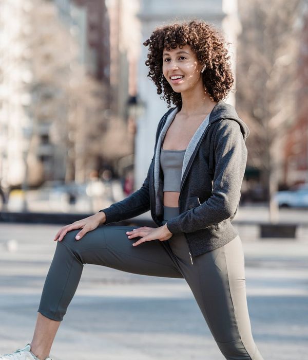 Woman feeling energetic and vibrant in a bright space.